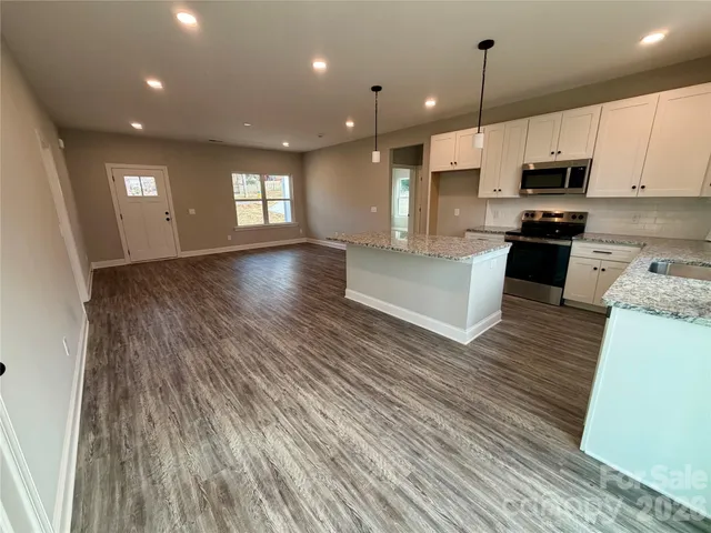 a view of kitchen with cabinets and wooden floor