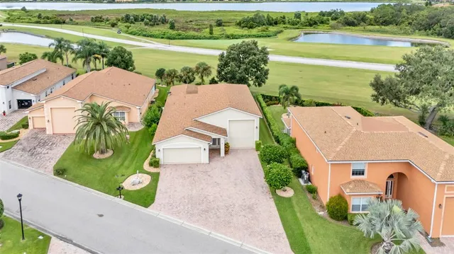 an aerial view of a house with outdoor space and lake view
