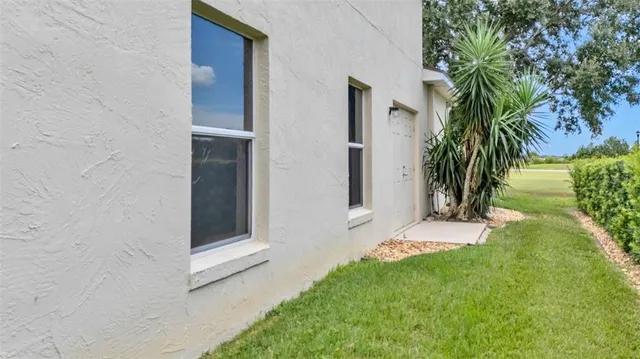 an aerial view of a city with lots of residential buildings ocean and mountain view in back