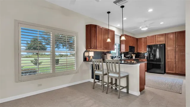 a view of a dining room with furniture a chandelier and wooden floor
