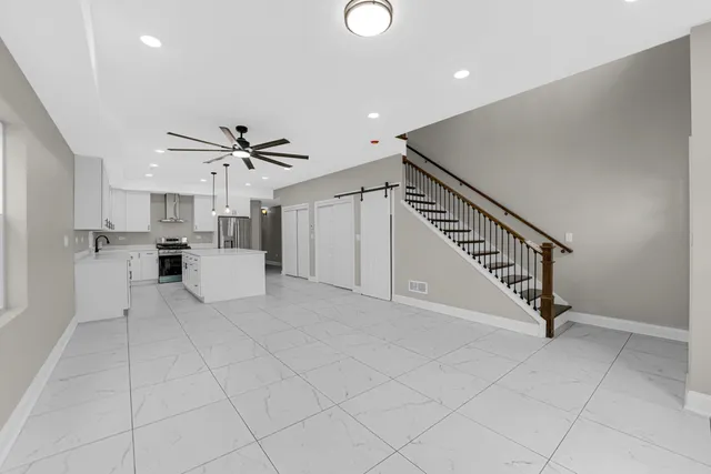 a view of kitchen with cabinets and window