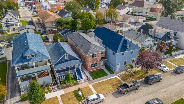 an aerial view of multiple houses with yard
