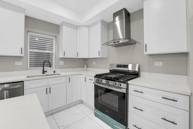 a kitchen with cabinets appliances and a sink