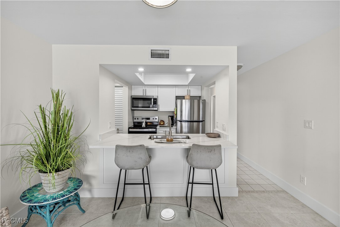 200 Lenell Road, Unit 214 Fort Myers Beach, FL 33931 - Photo 11 of 32 a view of a dining room with furniture and a potted plant