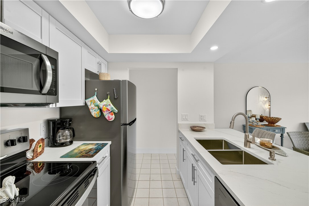 200 Lenell Road, Unit 214 Fort Myers Beach, FL 33931 - Photo 12 of 32 a kitchen that has a sink and a stove