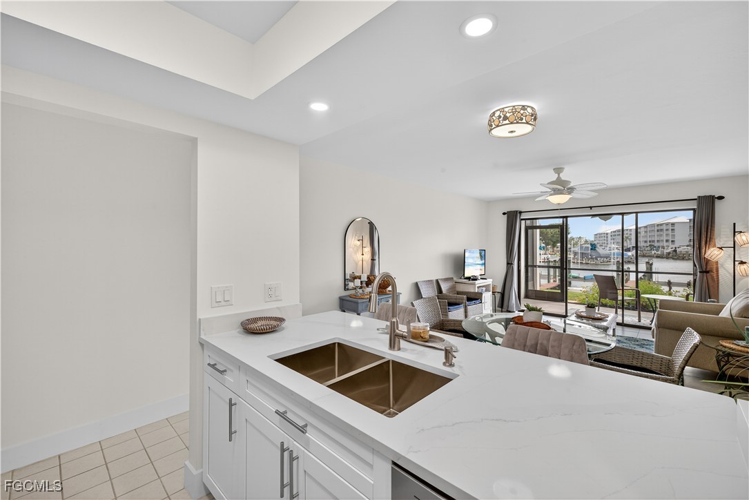 200 Lenell Road, Unit 214 Fort Myers Beach, FL 33931 - Photo 13 of 32 a kitchen with a sink and a refrigerator