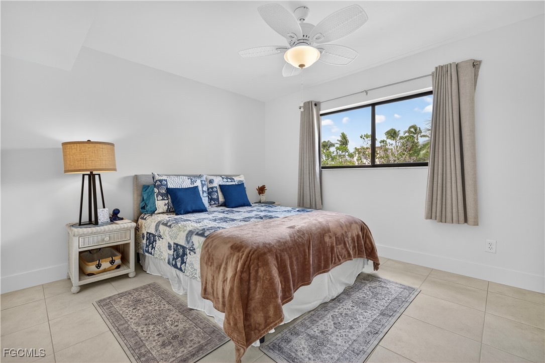 200 Lenell Road, Unit 214 Fort Myers Beach, FL 33931 - Photo 15 of 32 a bedroom with a bed and a painting on the wall