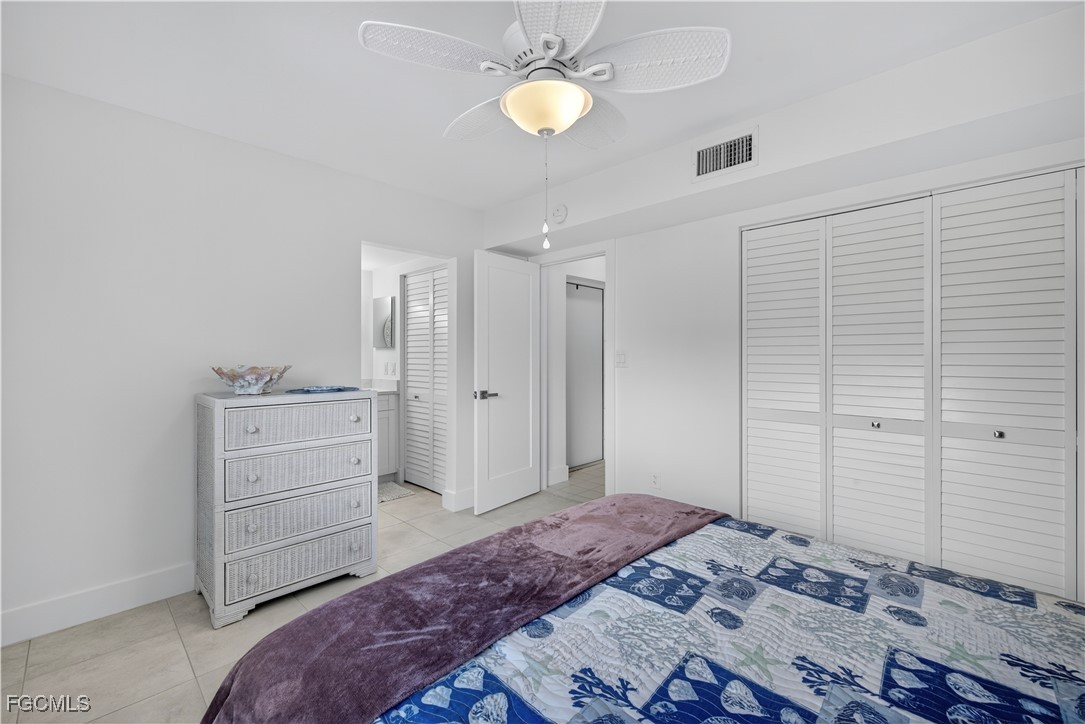 200 Lenell Road, Unit 214 Fort Myers Beach, FL 33931 - Photo 17 of 32 a bedroom with a bed and a chandelier
