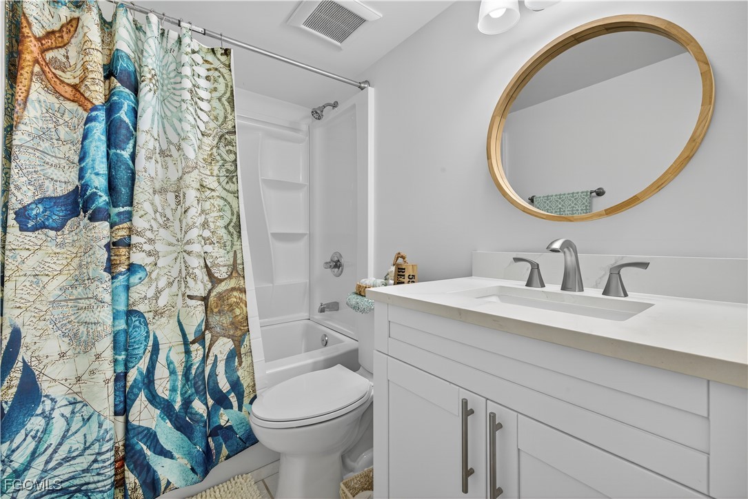 200 Lenell Road, Unit 214 Fort Myers Beach, FL 33931 - Photo 19 of 32 a bathroom with a sink a toilet and a mirror