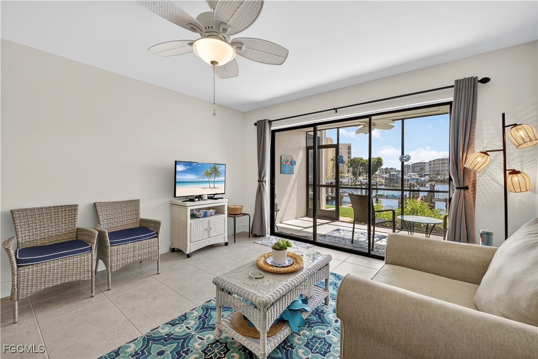 200 Lenell Road, Unit 214 Fort Myers Beach, FL 33931 - Photo 2 of 32 a living room with furniture and a floor to ceiling window