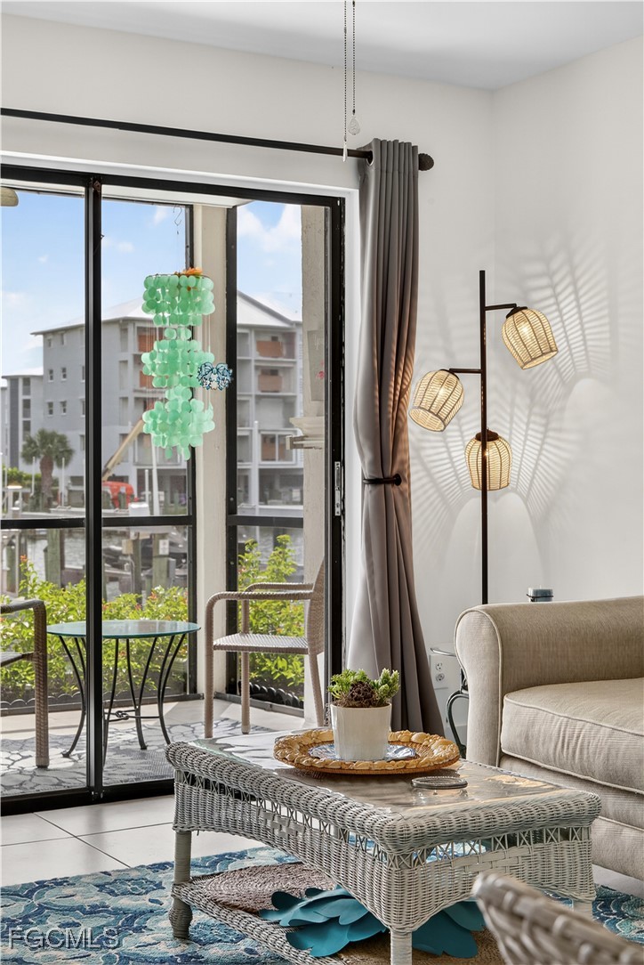 200 Lenell Road, Unit 214 Fort Myers Beach, FL 33931 - Photo 22 of 32 a living room with furniture and a floor to ceiling window