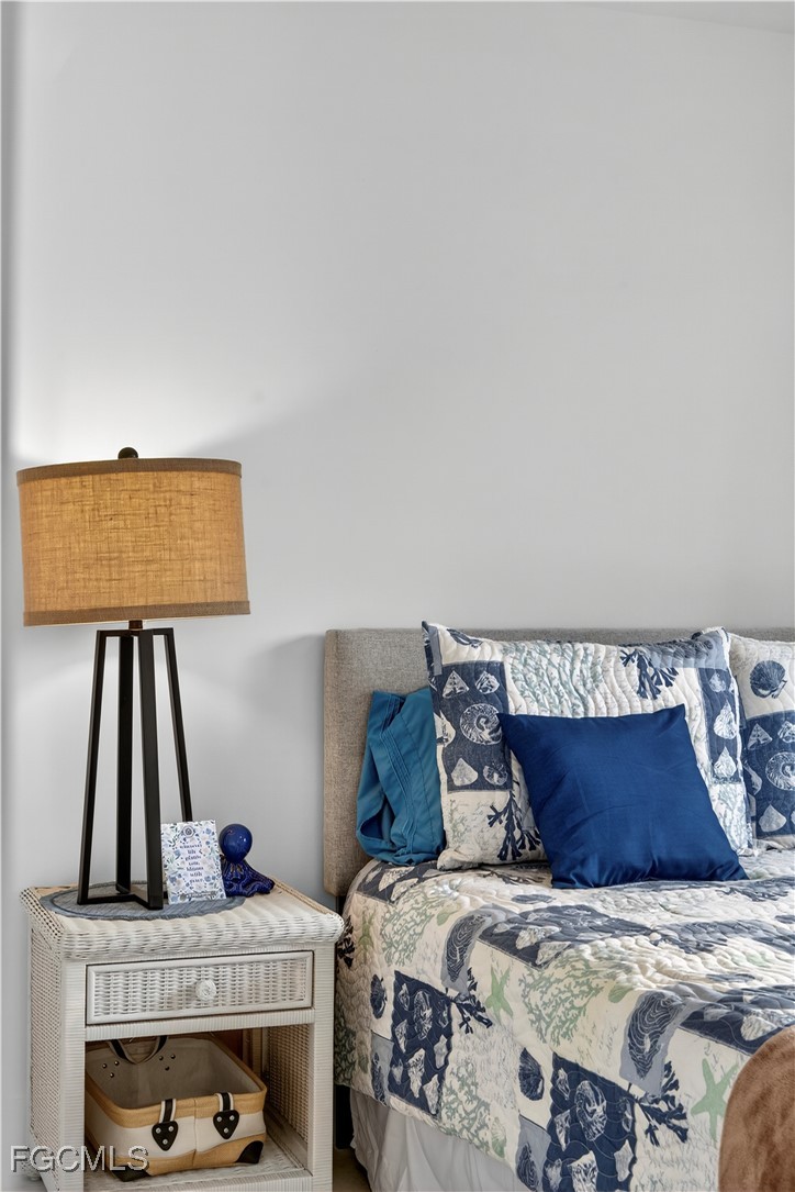 200 Lenell Road, Unit 214 Fort Myers Beach, FL 33931 - Photo 27 of 32 a bed sitting in a bedroom next to a window