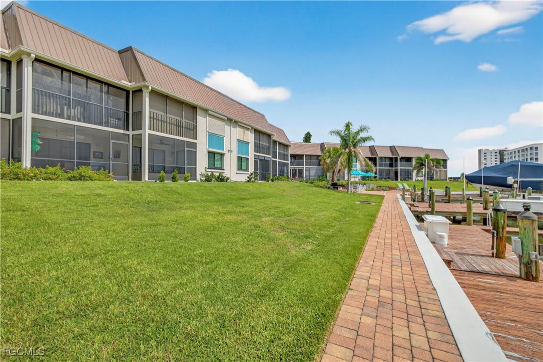 200 Lenell Road, Unit 214 Fort Myers Beach, FL 33931 - Photo 31 of 32 a view of building with yard