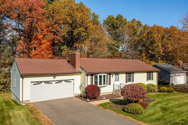 a front view of a house with yard garage and outdoor seating