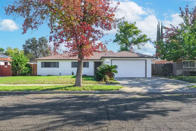 a front view of a house with a yard and a garage