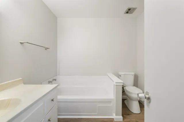 a bathroom with a toilet and a bathtub