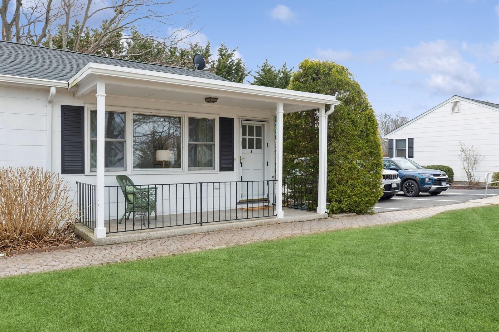 a view of a house with a small yard and a garden