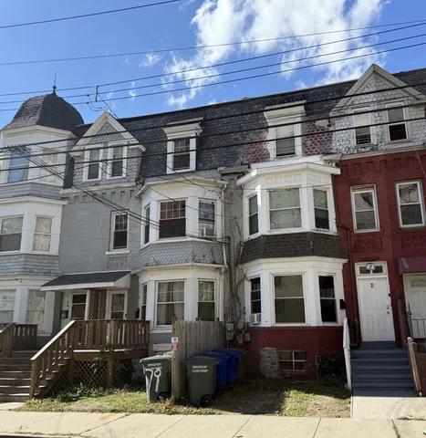 a front view of a residential apartment building with a yard