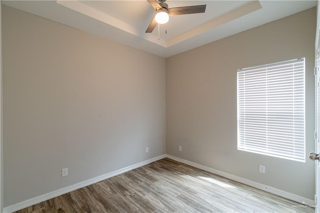 1005 West Kohala Avenue, Unit 4 Alton, TX 78573 - Photo 12 of 21 an empty room with a window and a fan