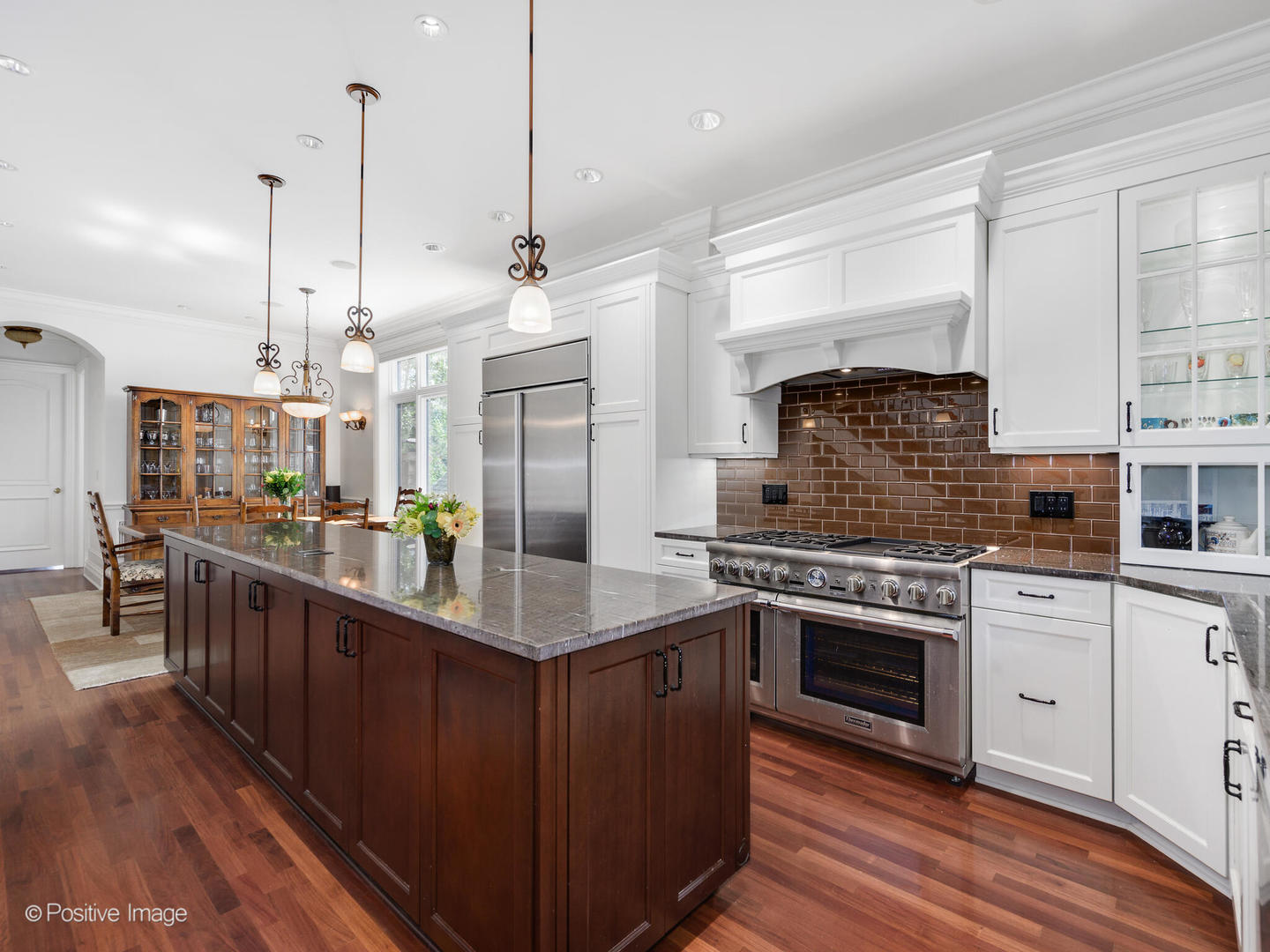 2019 North Mohawk Street, Unit 3 Chicago, IL 60614 - Photo 4 of 27 a kitchen with stainless steel appliances granite countertop a stove a sink dishwasher a refrigerator and a wooden cabinets