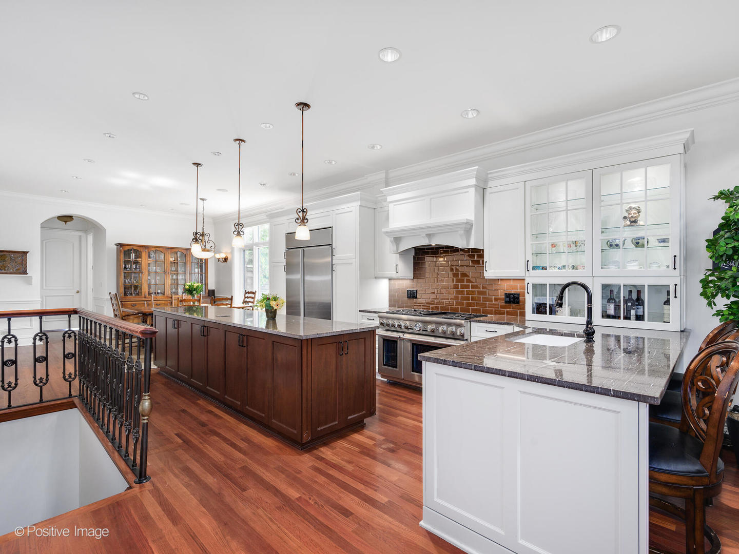 2019 North Mohawk Street, Unit 3 Chicago, IL 60614 - Photo 6 of 27 a kitchen with stainless steel appliances granite countertop a stove top oven a sink a refrigerator white cabinets and wooden floor