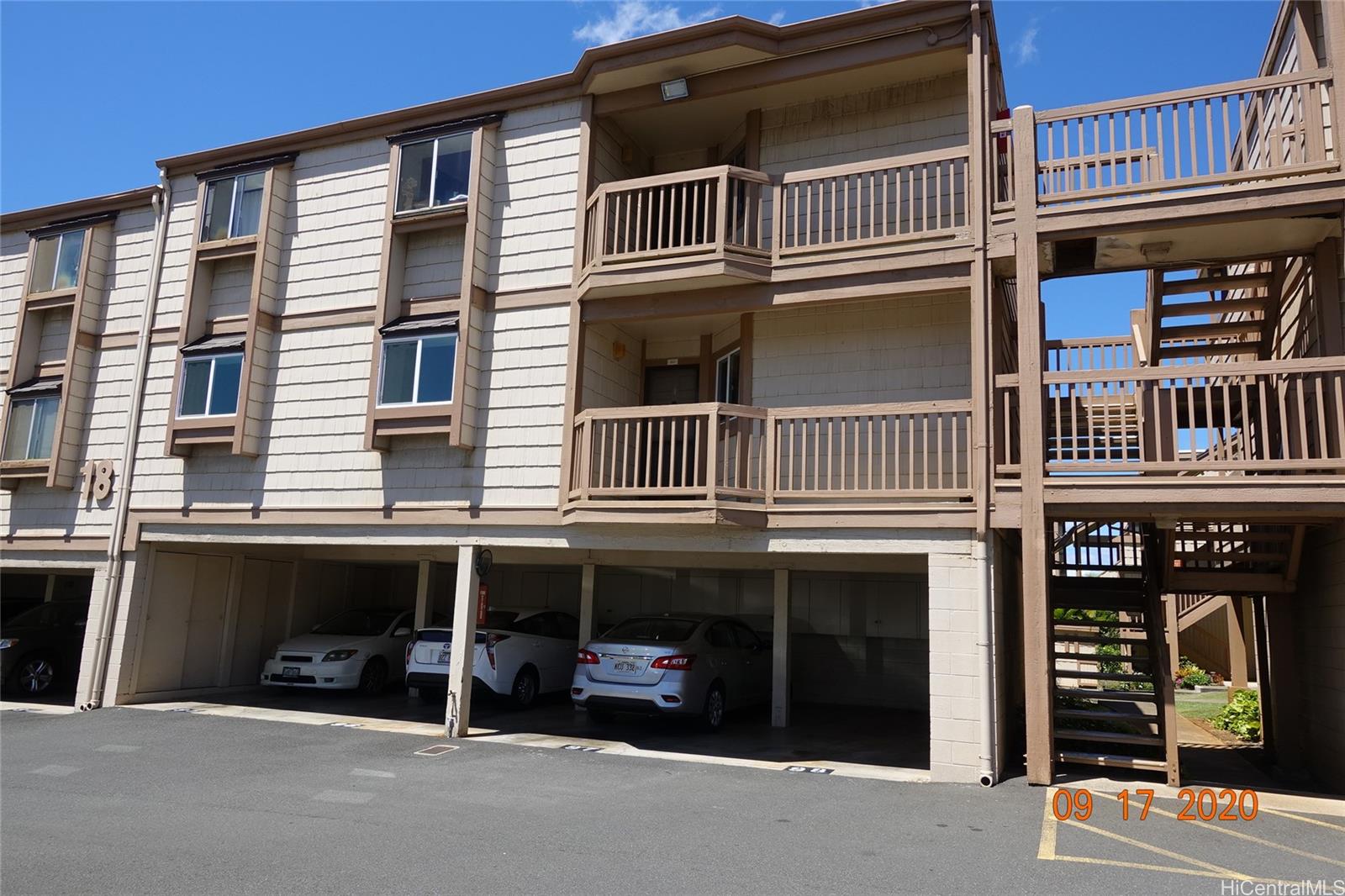98-943 Moanalua Road, Unit 1801 Aiea, HI 96701 - Photo 1 of 1 a front view of a house with a parking space