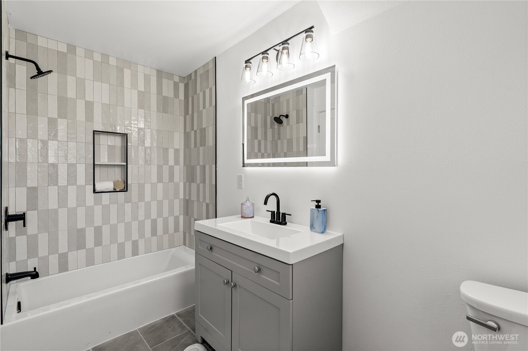 4706 Southwest Eddy Street Seattle, WA 98136 - Photo 13 of 27 a bathroom with a sink a toilet and shower