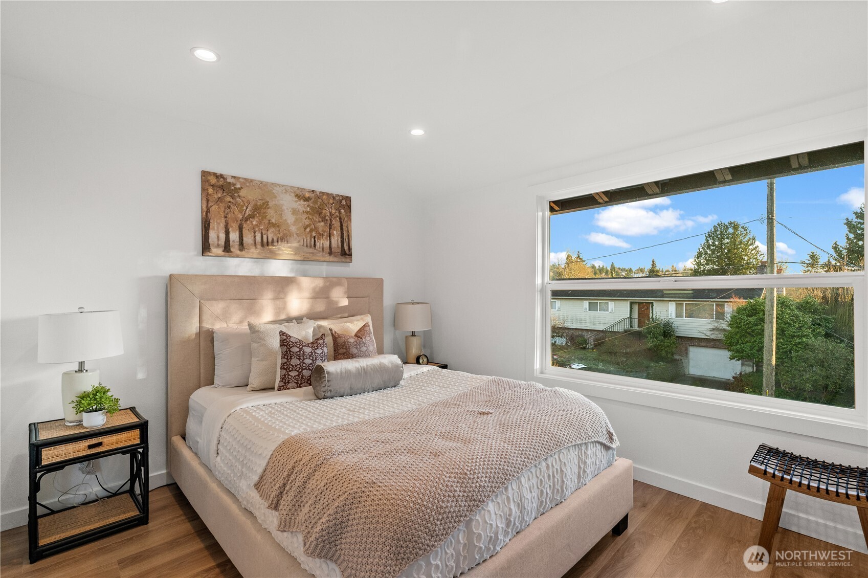4706 Southwest Eddy Street Seattle, WA 98136 - Photo 18 of 27 a bedroom with a large bed and a large window