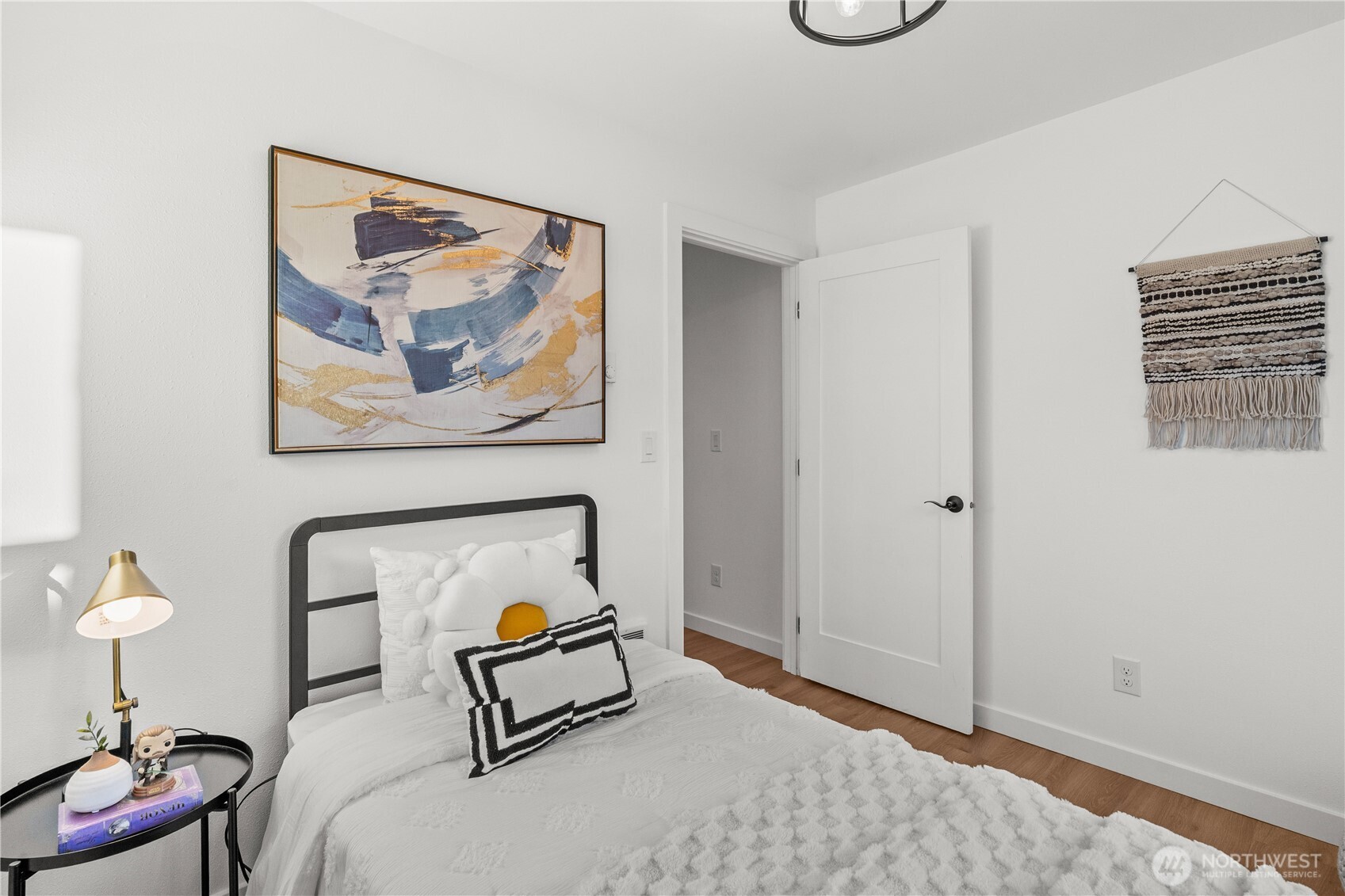 4706 Southwest Eddy Street Seattle, WA 98136 - Photo 22 of 27 a bedroom with a bed and a painting on the wall