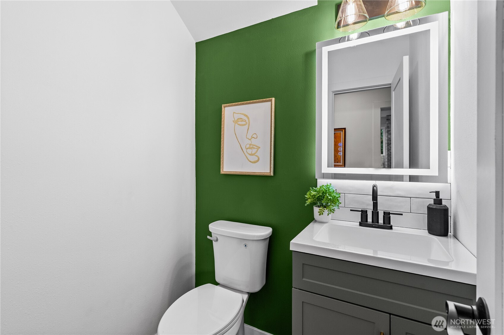 4706 Southwest Eddy Street Seattle, WA 98136 - Photo 23 of 27 a bathroom with a toilet sink and mirror