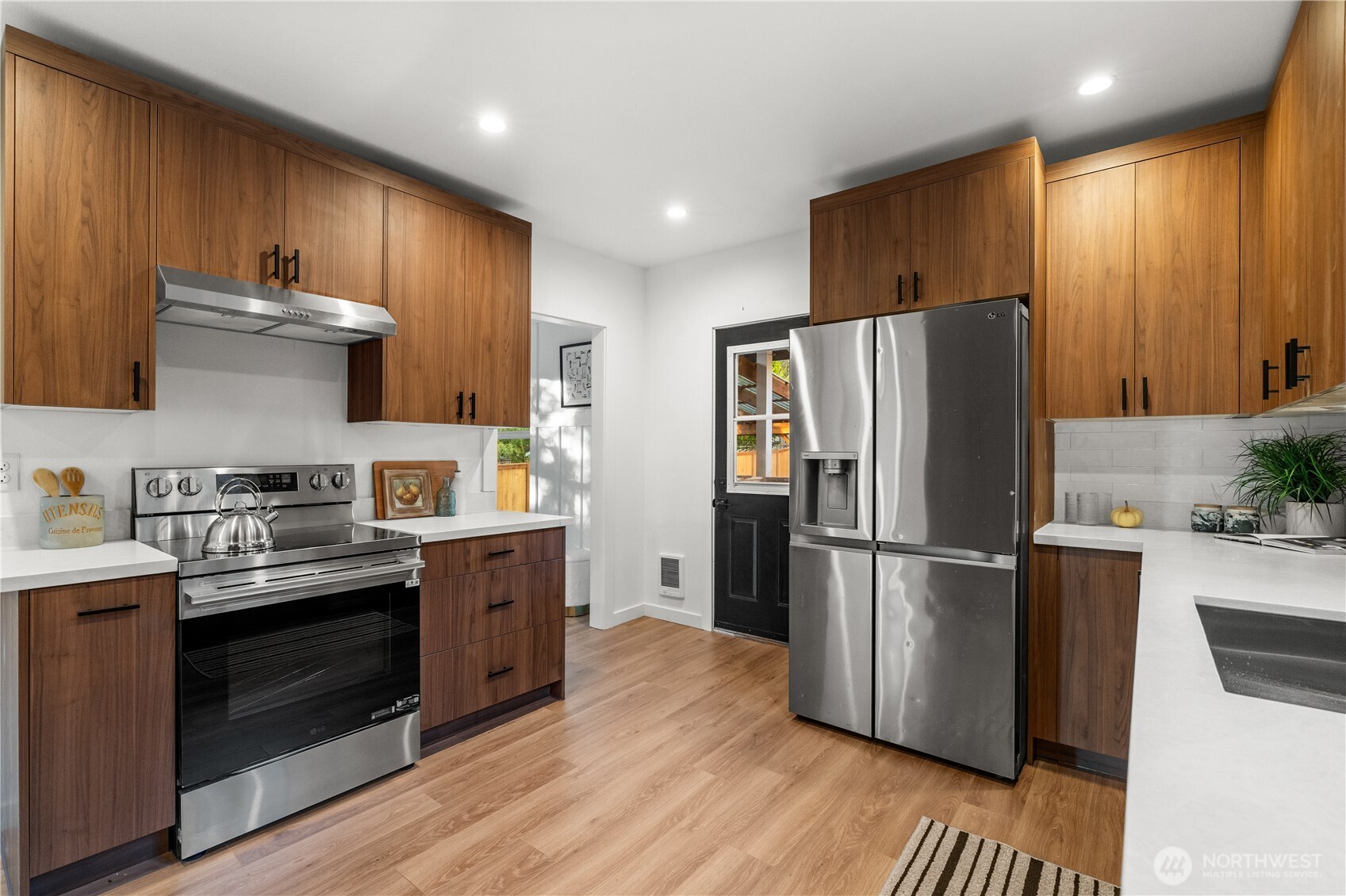 4706 Southwest Eddy Street Seattle, WA 98136 - Photo 9 of 27 a kitchen with stainless steel appliances a refrigerator stove and sink