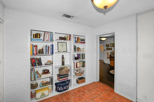 a bedroom with a bed and a book shelf