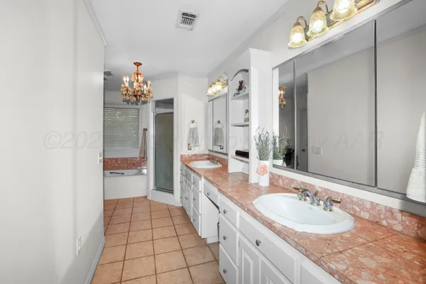 a spacious bathroom with a granite countertop sink a mirror and a shower
