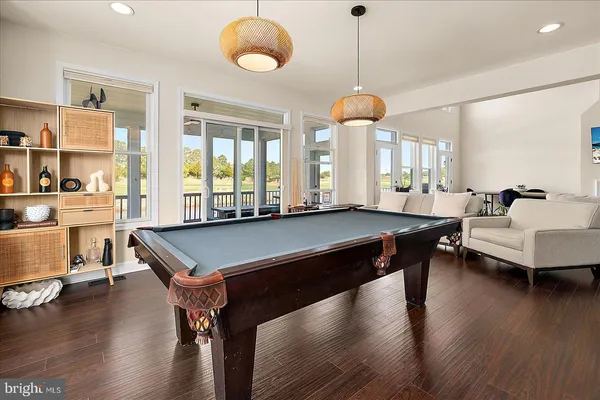 a kitchen with a dining table chairs and a sink