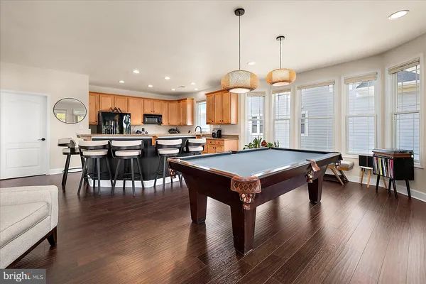 a large kitchen with lots of counter top space and stainless steel appliances