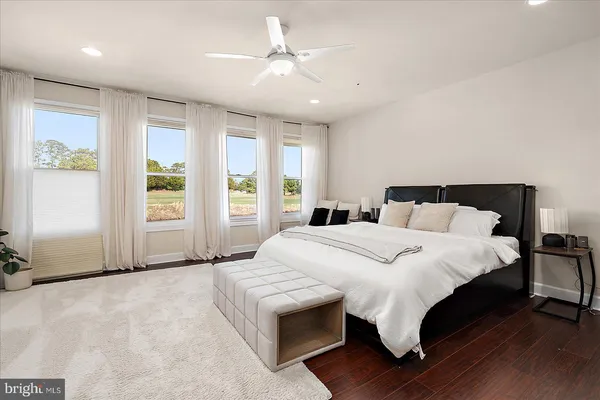 a bathroom with a granite countertop sink a toilet and bathtub