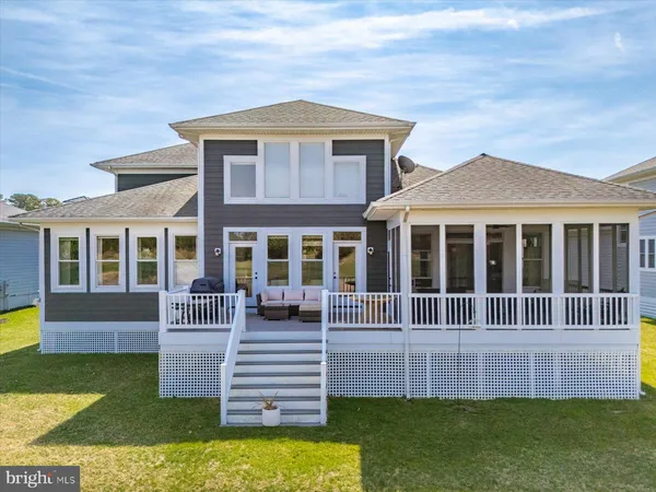 a view of a house with large windows and a couch