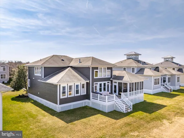a living room with furniture tv and large windows
