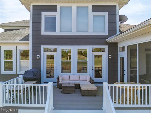 a living room with furniture and floor to ceiling windows
