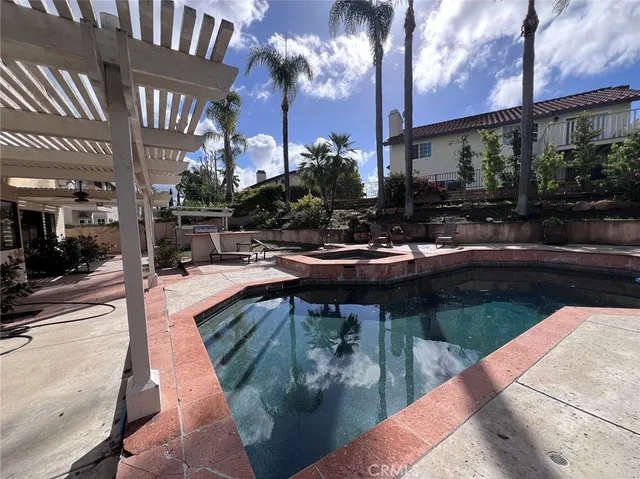 a swimming pool with outdoor seating and yard