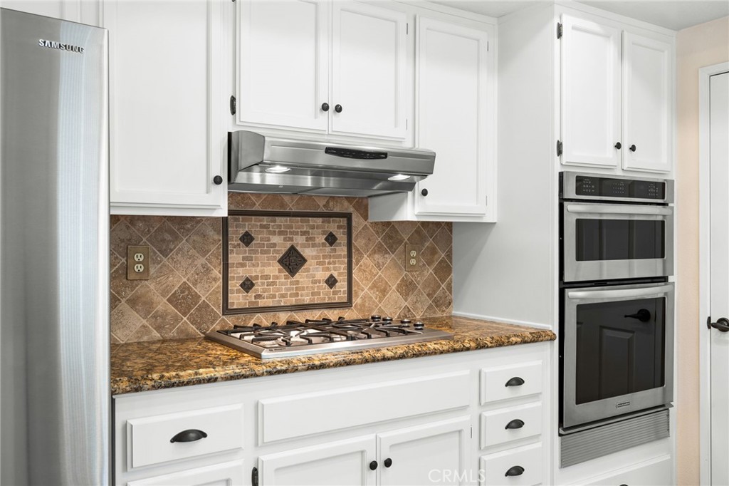 855 Ave Bernardo San Dimas, CA 91773 - Photo 20 of 65 a kitchen with granite countertop white cabinets and stainless steel appliances
