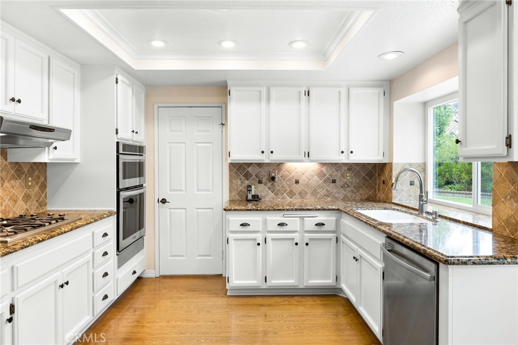 855 Ave Bernardo San Dimas, CA 91773 - Photo 21 of 65 a kitchen with granite countertop a sink stove and cabinets