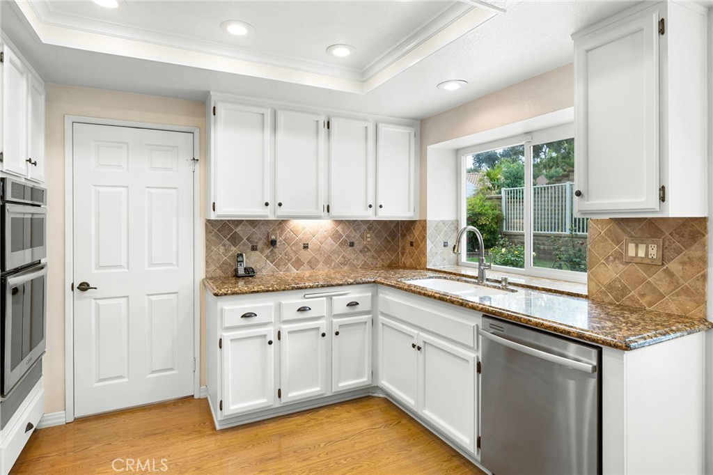 855 Ave Bernardo San Dimas, CA 91773 - Photo 22 of 65 a kitchen with granite countertop white cabinets and white appliances