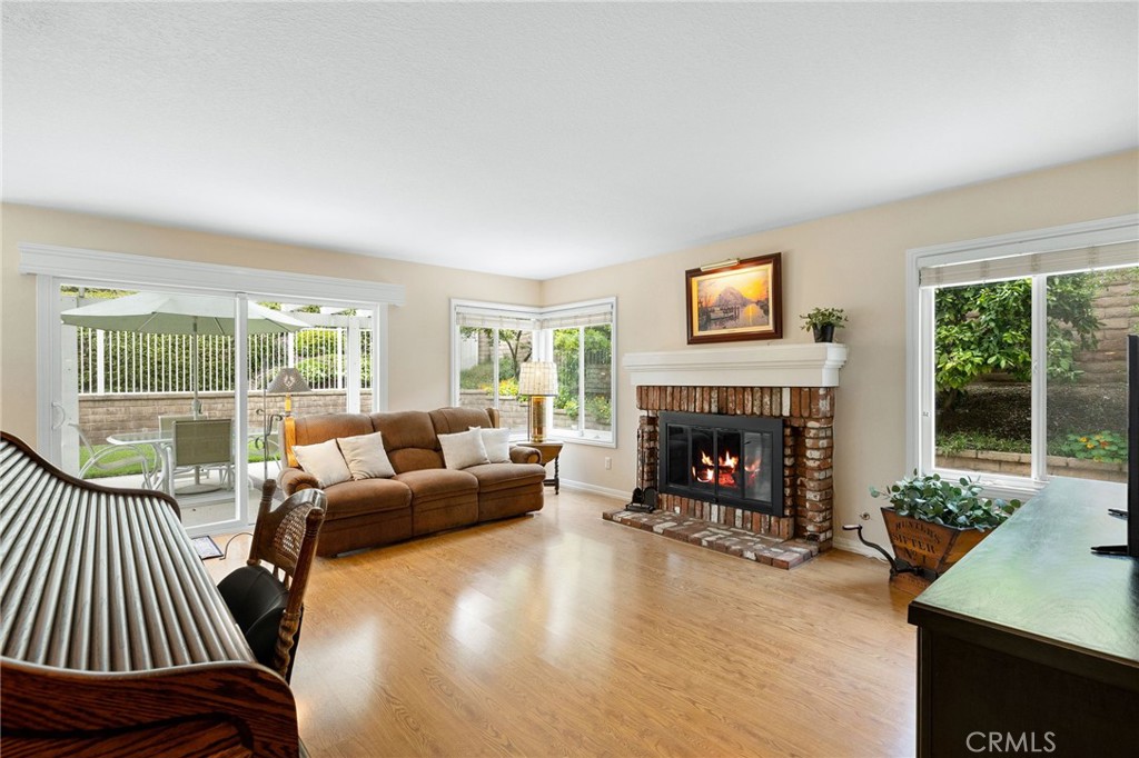 855 Ave Bernardo San Dimas, CA 91773 - Photo 27 of 65 a living room with furniture a fireplace and floor to ceiling window