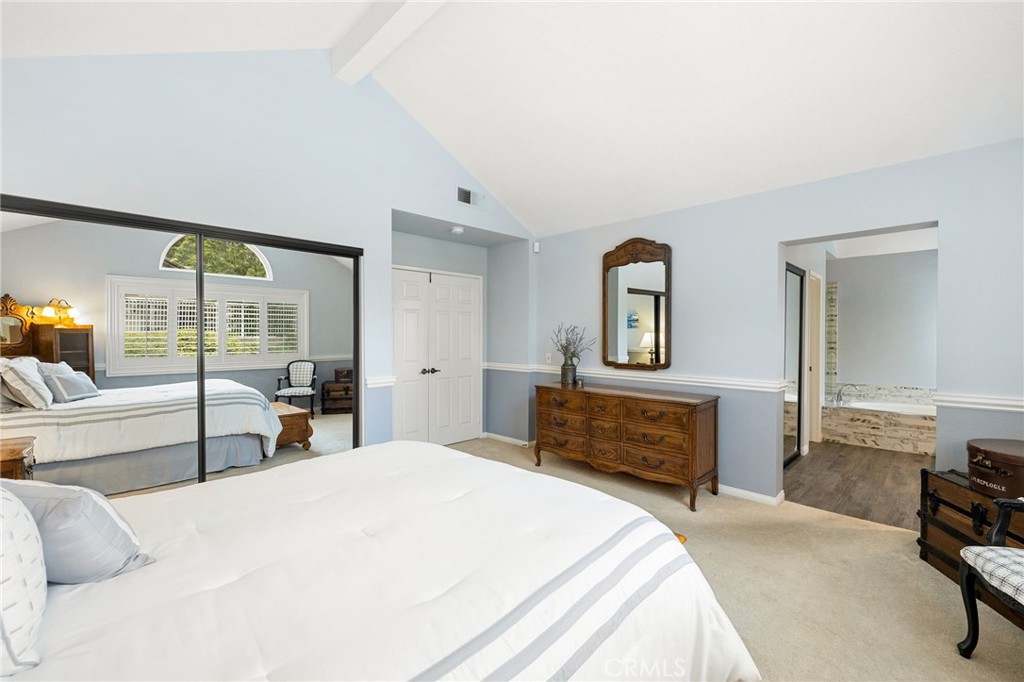 855 Ave Bernardo San Dimas, CA 91773 - Photo 35 of 65 a bedroom with a bed and a dresser with mirror