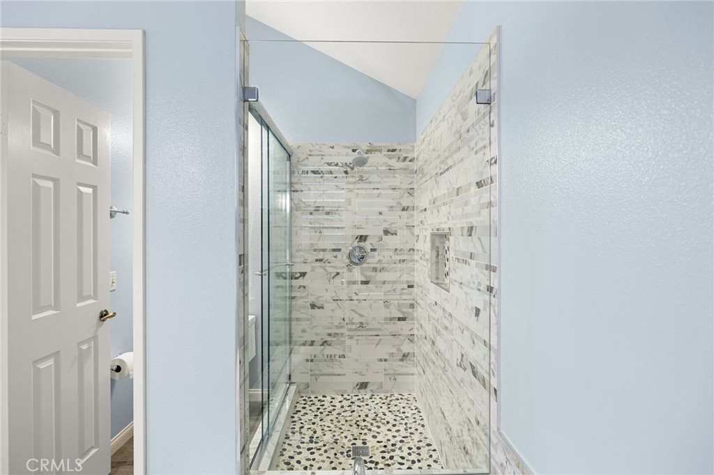855 Ave Bernardo San Dimas, CA 91773 - Photo 39 of 65 Custom tiled shower with glass enclosure door.