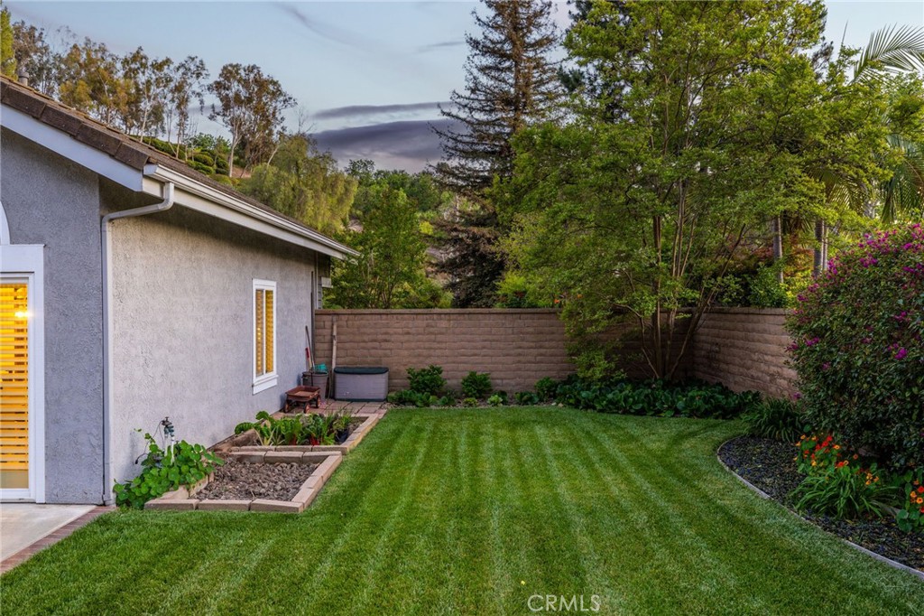 855 Ave Bernardo San Dimas, CA 91773 - Photo 52 of 65 Side yard with grass, RV potential, and garden beds.