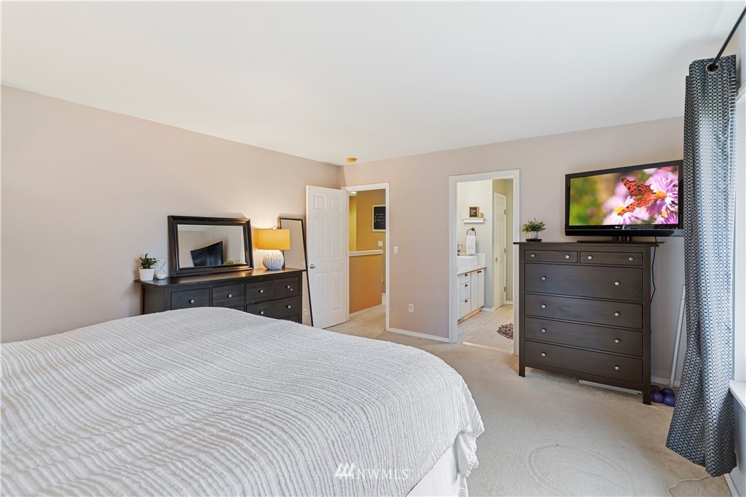5042 Northeast 4th Place Renton, WA 98059 - Photo 13 of 29 a bedroom with a bed and a flat screen tv