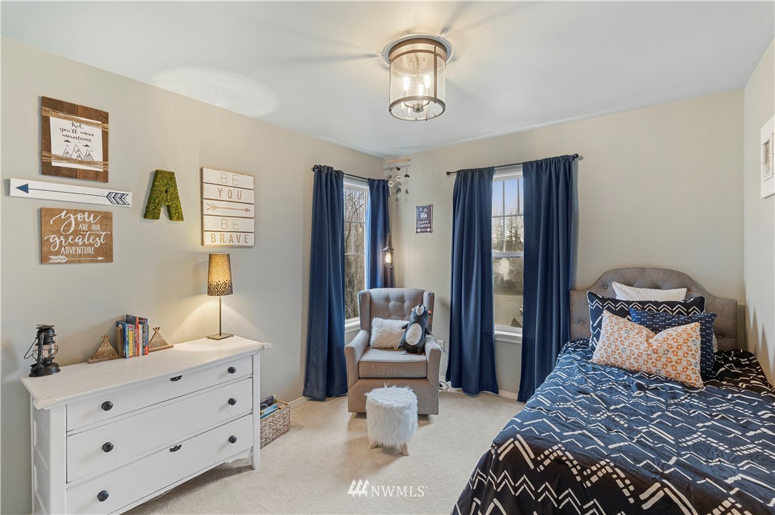 5042 Northeast 4th Place Renton, WA 98059 - Photo 17 of 29 a bedroom with a bed and wooden floor