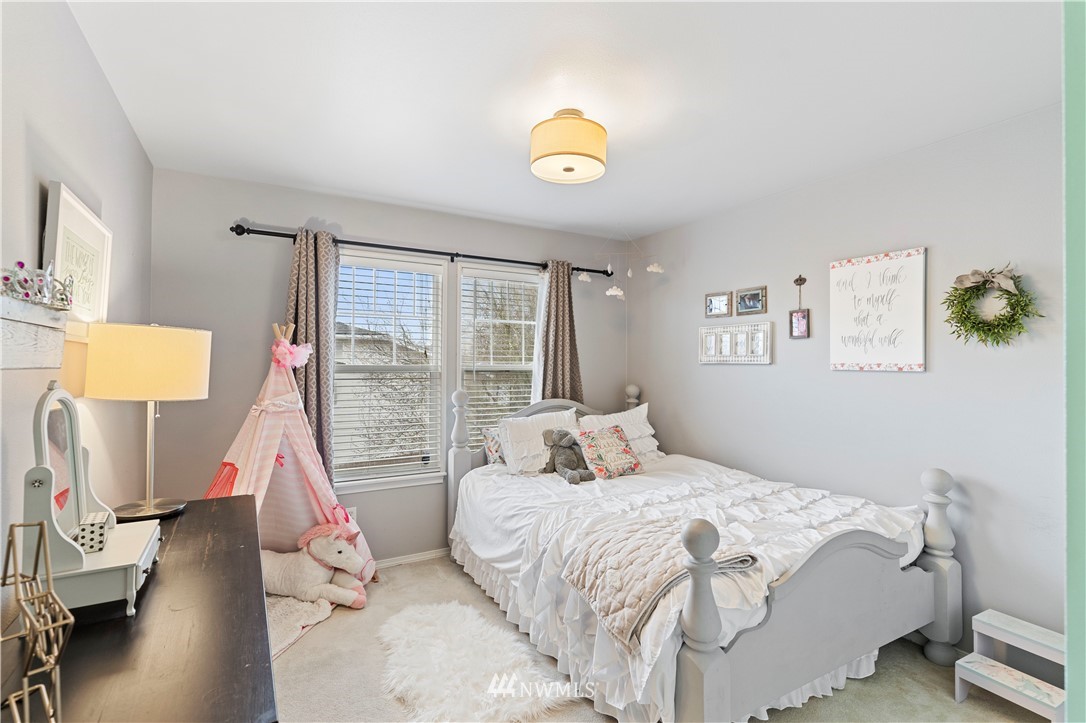 5042 Northeast 4th Place Renton, WA 98059 - Photo 18 of 29 a bedroom with a bed and a window